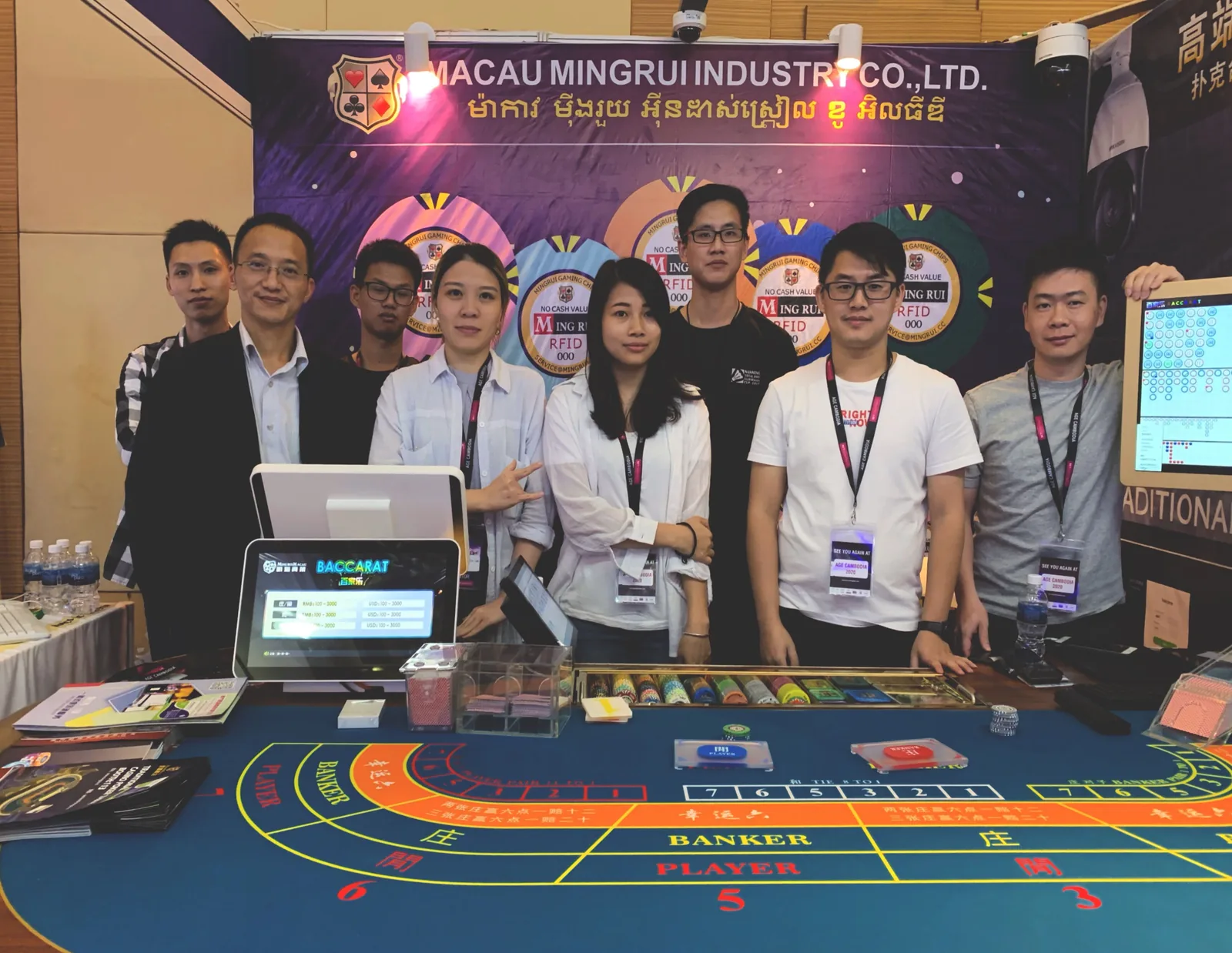 Casino equipment trade-show booth showing RFID chips and a baccarat display system